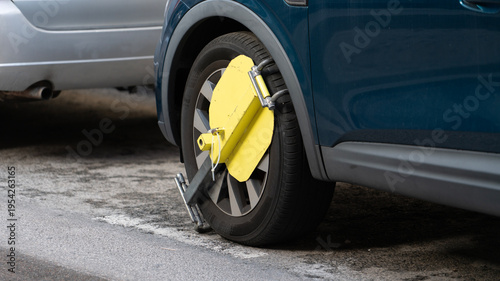 Принти на полотні Car wheel locked with parking clamp for illegal parking