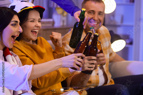 Soccer fans with beer watch...