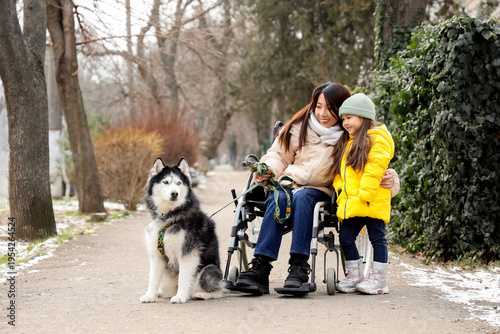 Young Asian mother in wheel...