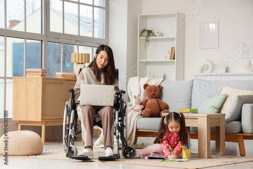 Young Asian mother in wheel...