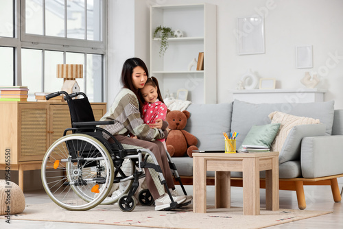 Young Asian mother in wheel...