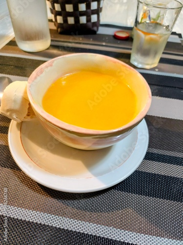 close view of a pumpkin soup in a small bowl