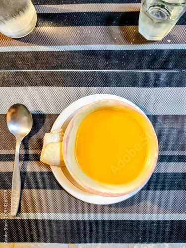 flat lay  view of a pumpkin soup in a small bowl