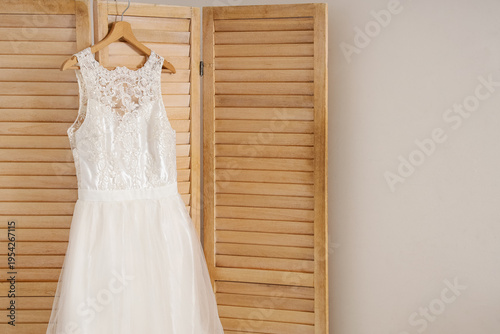 Wedding dress hanging on fo...