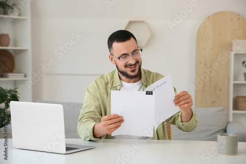 Happy young man with refund...