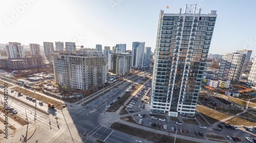 A timelapse of a high-rise view of an intersection in a residential area of ​​multi-story buildings and skyscrapers.