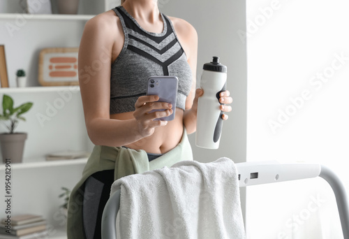 Sporty woman with mobile ph...