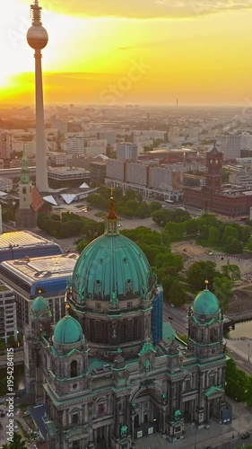  Aerial view of Famous Berlin cathedral at sunrise with famous television tower is in the background. Berlin, Germany