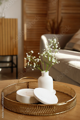Tray with white candle and ...