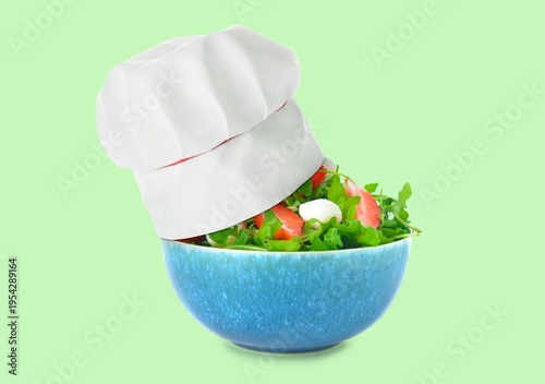 Cook hat and fresh salad on...