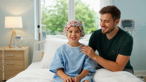 Young cancer patient girl with father in hospital room showing thumbs up and smiling while sitting on bed after chemotherapy