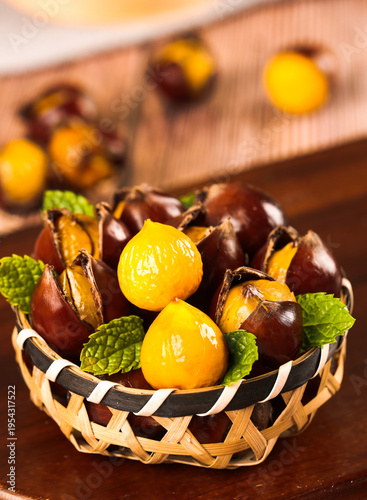 Fresh Roasted Chestnuts in Wicker Basket with Mint Leaves Studio Photography