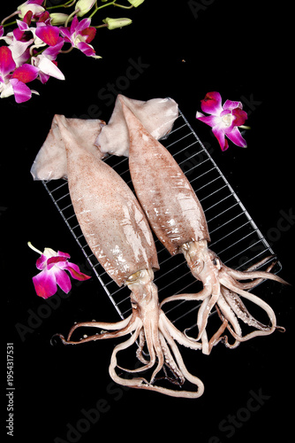 Fresh Raw Squid on Grill with Orchid Flowers Studio Food Photography