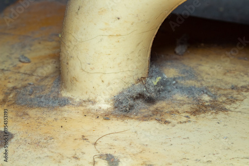 Photos A dirty pipe base with dark dust and grime on a light surface for backgrounds