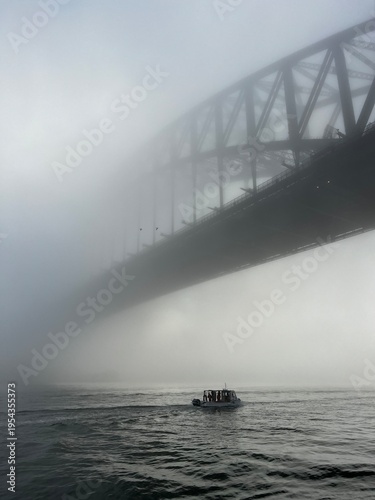 Boat Passing Beneath Sydney Harbour Bridge in Dense Fog