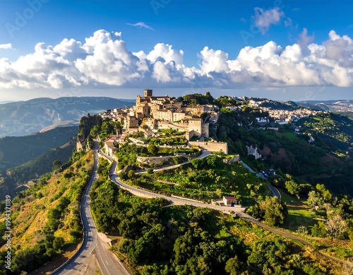 Wallpaper Mural Aerial view captures a charming hilltop town with ancient buildings and winding roads amidst lush, green vegetation Torontodigital.ca