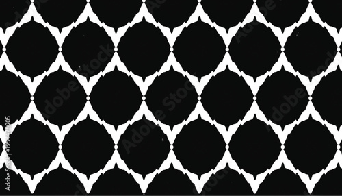 A monochromatic black and white ikat textile pattern features repeating diamond or eye shapes in a seamless.