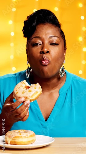 Woman eating donuts in studio setting.