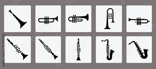 Icon set of musical wind instruments including clarinets, trumpets, trombone, and saxophones, showcasing brass and woodwind silhouettes for music design and stock use.