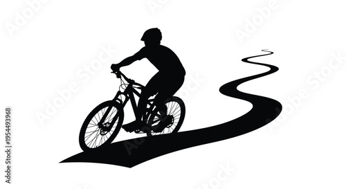 Mountain biker riding on a winding path dramatic black silhouette