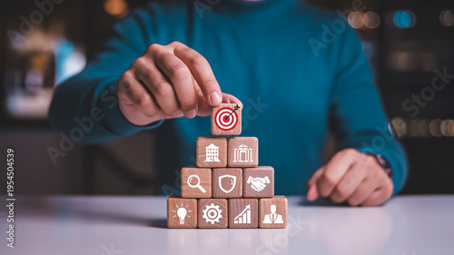 Businessman Building Strategy Concept With Wooden Blocks On White Table