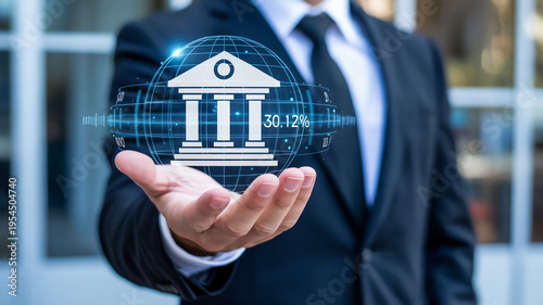 Businessman Holding Virtual Bank Building Icon With Financial Data For Banking Concept