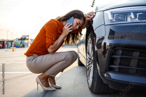 Photography Stressed woman calling for roadside assistance near broken car
