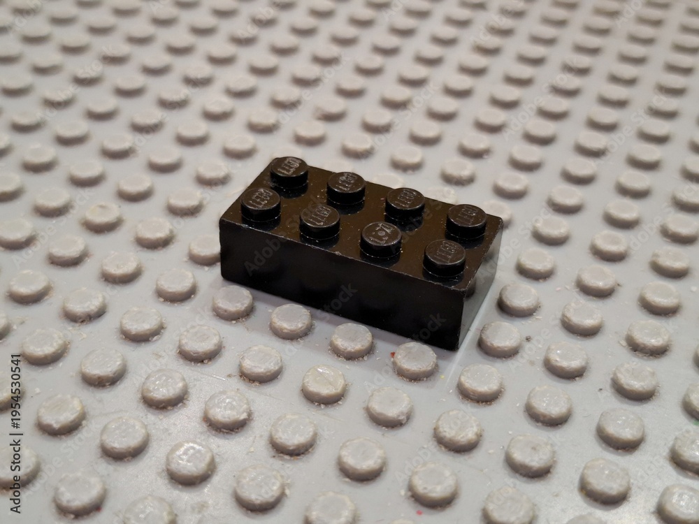 Fototapeta premium Lego Plastic Building Block Piece Attached to Studded Baseplate Surface for Creative Construction and Educational Child Development Hobby Play on December 19, 2025 in Bangkok, Thailand