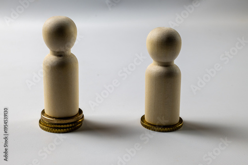 Salary inequality concept with wooden figures