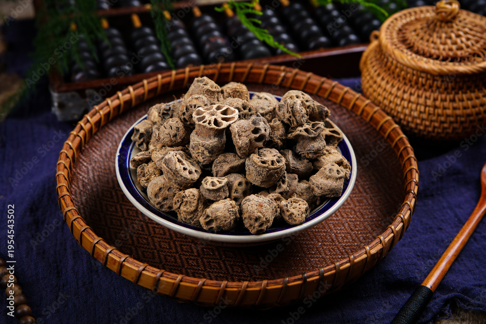 Fototapeta premium Dried medicinal roots in bowl on woven tray
