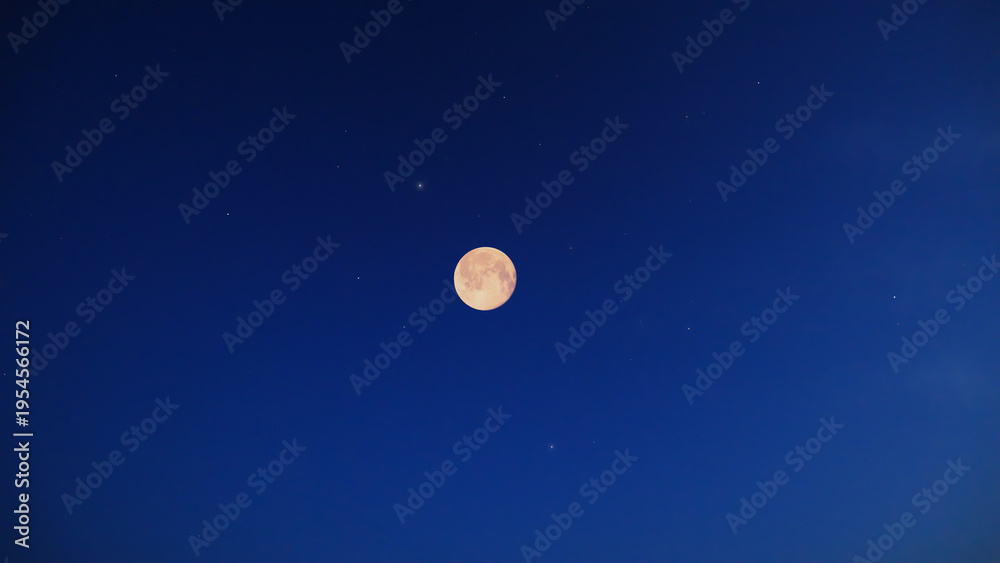 Fototapeta premium Lunar eclipse on a starry Milky Way background.
