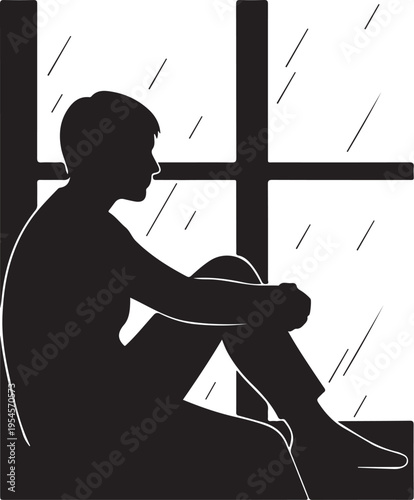 Silhouette of a man sitting by a rainy window