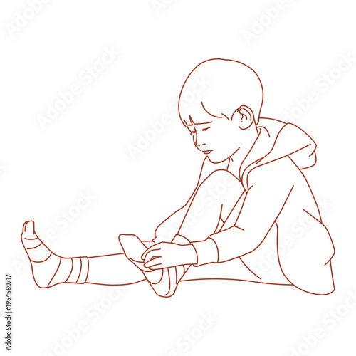  boy sitting and putting on socks for school.eps