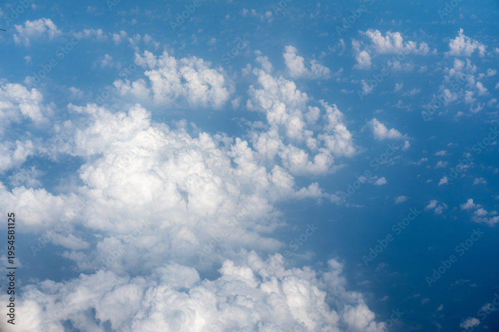 Fototapeta premium Blue Sky with White Clouds, Flying above Sunny Cloudy Sky Texture Pattern Plane View
