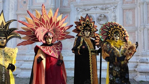 Venice, Italy - February, 2026 - People dressed in masks for the Venice Carnival have their photos taken by tourists	
