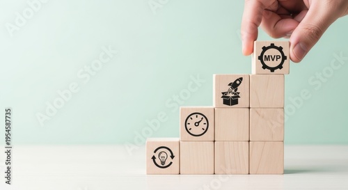 Hand placing MVP block on top of wooden step structure