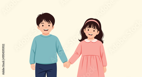 Cute young boy and girl hold hands and smile happily while standing together against a warm cream background.