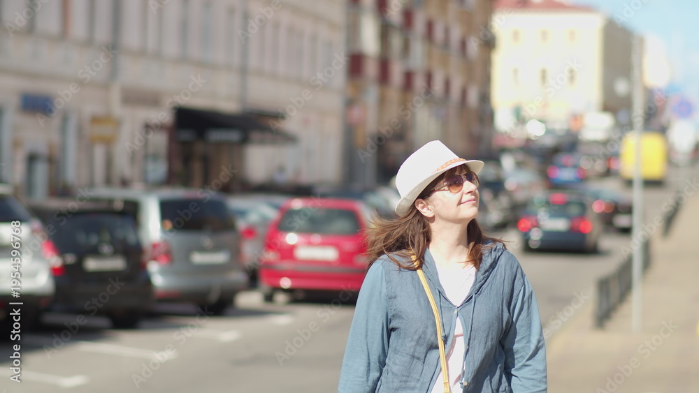 Fototapeta premium Young Woman Walking in City Street on Sunny Day, have fun and enjoy