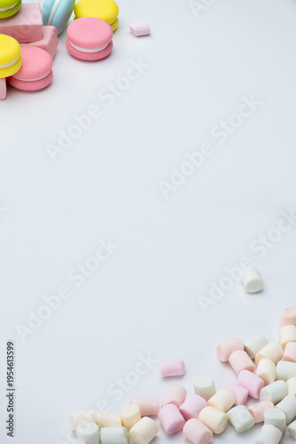 Macarons and colorful marshmallows on a white background
