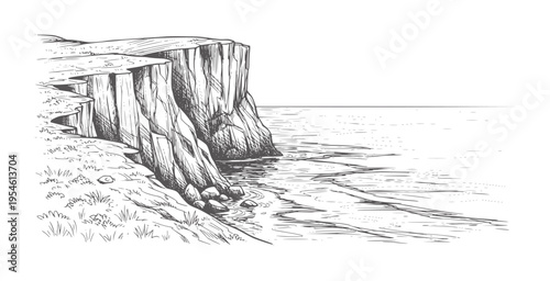 Of a rugged cliff face meeting the ocean with grassy shoreline water waves