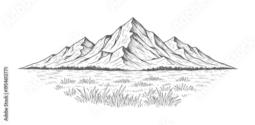 Of jagged mountain peaks reflected in a calm lake with grassy foreground reflection