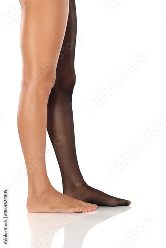 Фотография Side view of a woman’s legs showing one bare and one in sheer black pantyhose, s
