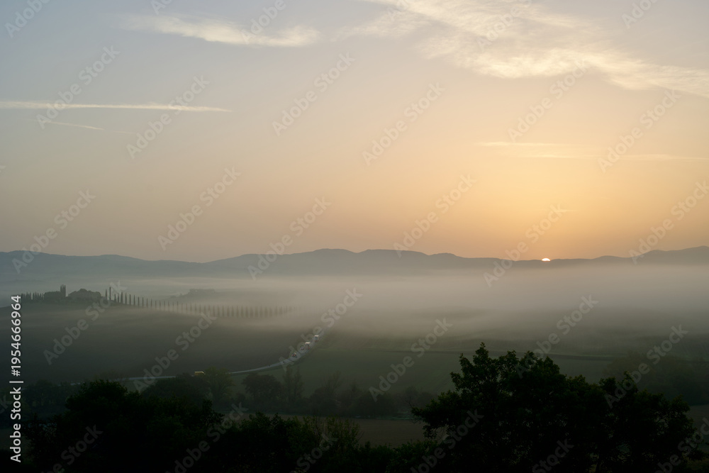 Fototapeta premium Misty Sunrise over Rolling Hills in Siena Province, Tuscany, Italy