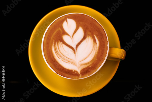 Top‑down view of latte art in yellow cup