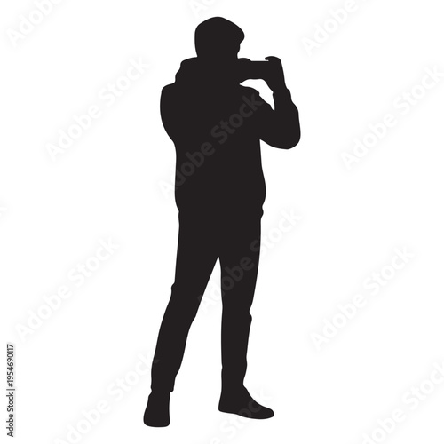 A photographer captured in a striking black silhouette intently focused on their subject silhouette