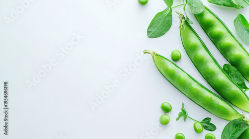 Fresh green pea pods with vibrant leaves and peas arranged on light background create refreshing and natural feel