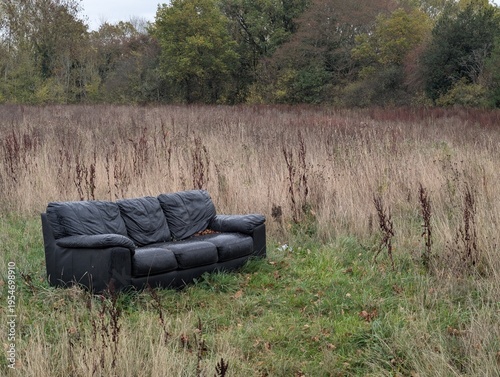 Photography Fly tipped sofa on farmland