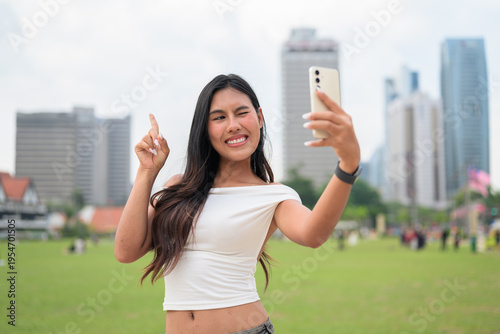 Canvas Print Cute woman smiling outdoors at Merdeka Square with Kuala Lumpur city skyline and
