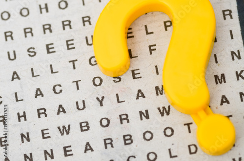 Photography Yellow Question Mark Symbol on a Word Search Puzzle Background