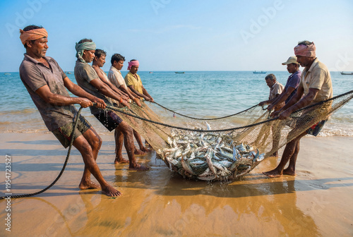 Group of local fishermen working together to pull a heavy net full of fresh fish onto a sandy beach. Traditional coastal teamwork, labor and industry.